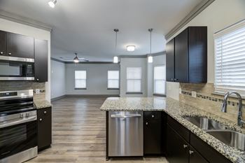 Open concept kitchen with island and stainless appliances